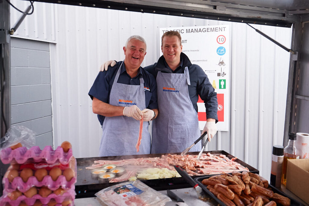 two guys enjoying a work barbecue